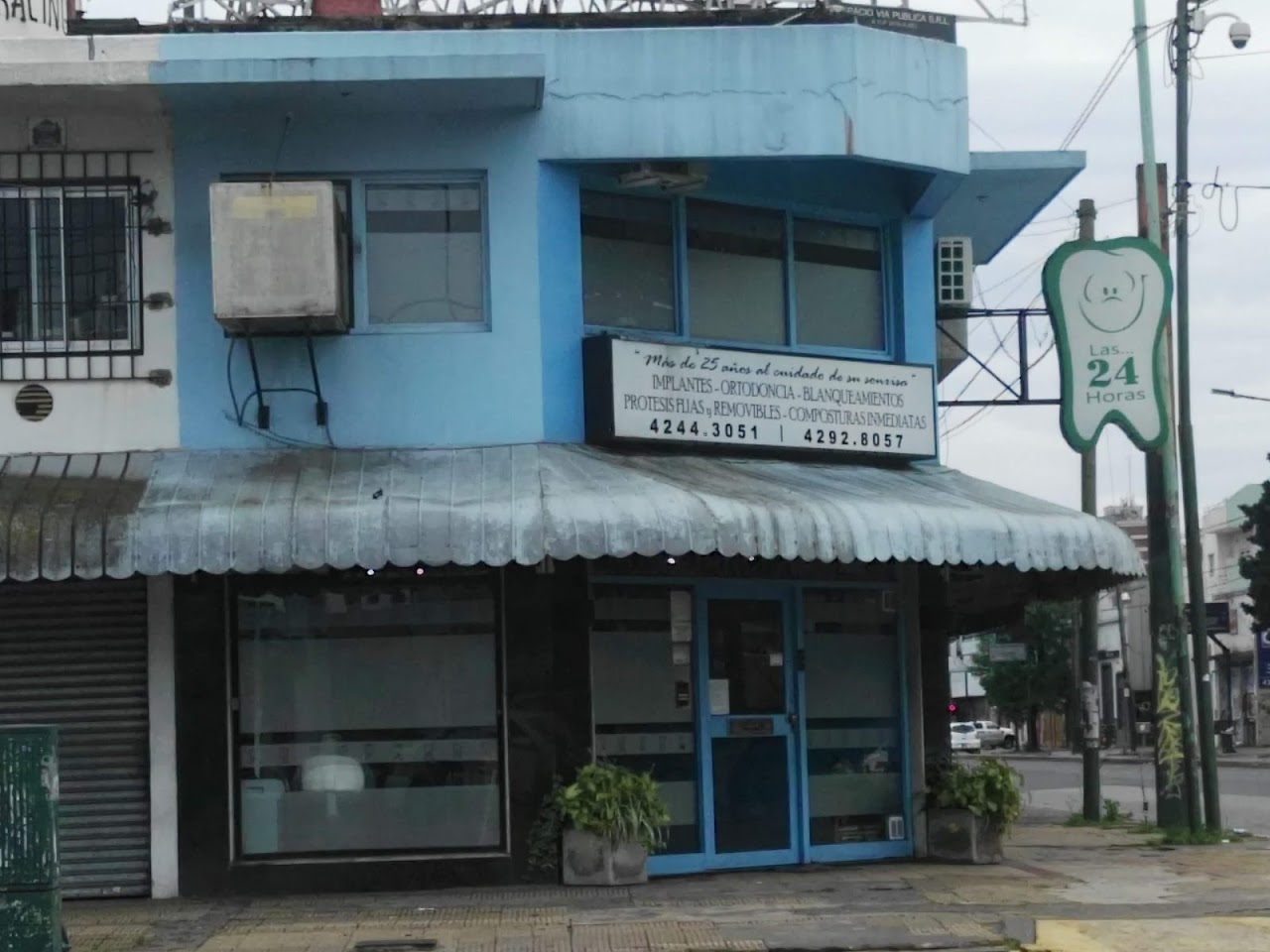Fachada moderna del consultorio odontológico sobre Av. Hipólito Yrigoyen en Temperley, iluminada de manera cálida y profesional